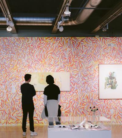 two people looking at art on wall in gallery