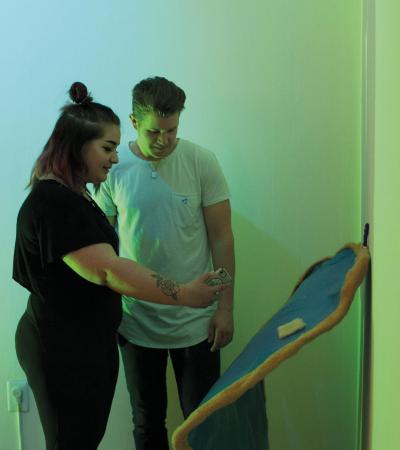 students looking at artwork in gallery