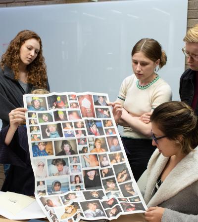 students looking at poster