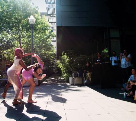 Two people dancing together in front of a crowd