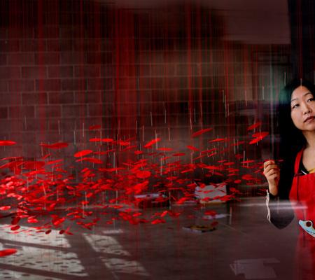 beili liu working on red installation piece