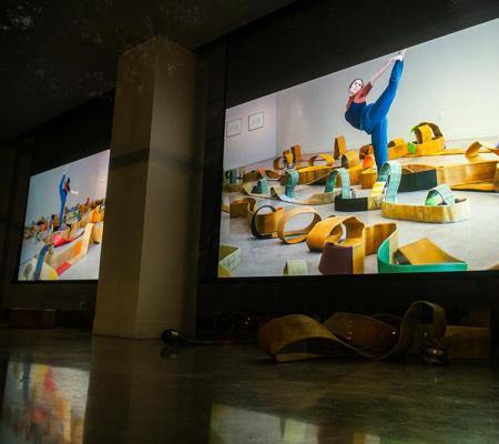 Visual Arts Center gallery south lawn projection of dancers improvising among the work of artist Madeline Hollander in Score for 7 Solos