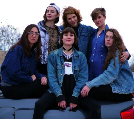 woman dressed in various pieces of jean clothing grouped together on a truck