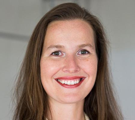 Headshot of Professor Astrid Runggaldier in front of a blurred background.