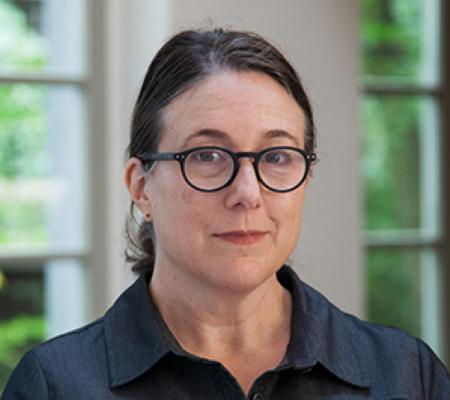 Headshot of Professor Teresa Hubbard in front of a blurred background.