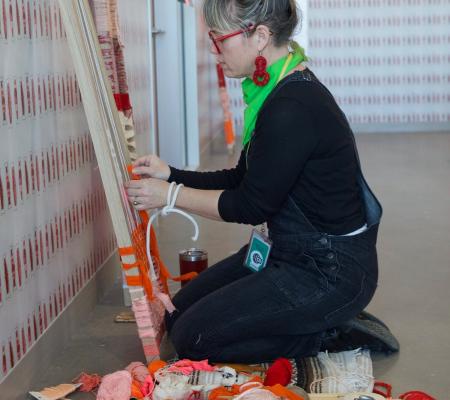 image of Jade Walker creating art while kneeling on the ground