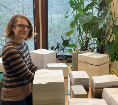 UT Austin alumna Bethany Johnson in her studio surrounded by compacted layered works