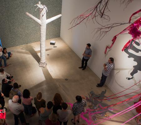 people listening to speaker during gallery talk