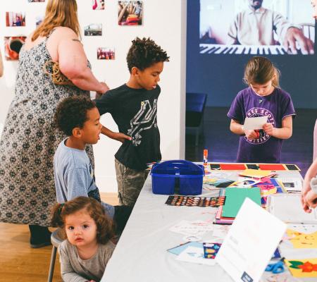 image of children participating in arts activities at UT Austin's Family Day at the VAC, the contemporary art gallery on campus