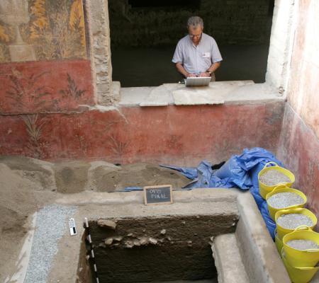 john clarke examining his work on site of oplontis