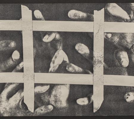 black and white image of fingers pressed against glass